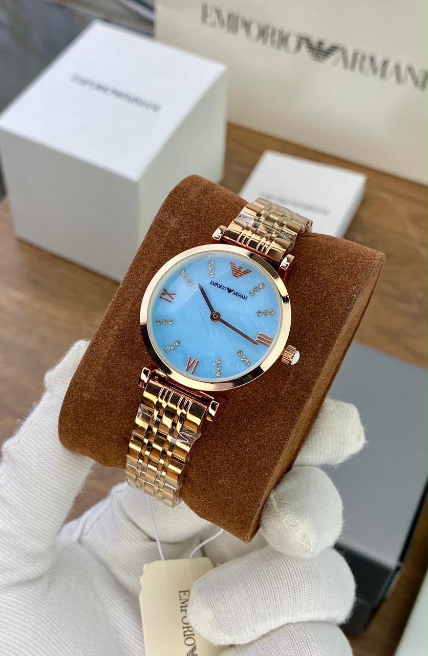 EMPORIO ARMANI WATCH A ROSE GOLD TONE STAINLESS STEEL BRACELET AND A LIGHT BLUE DIAL