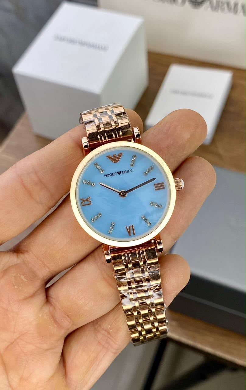 EMPORIO ARMANI WATCH A ROSE GOLD TONE STAINLESS STEEL BRACELET AND A LIGHT BLUE DIAL