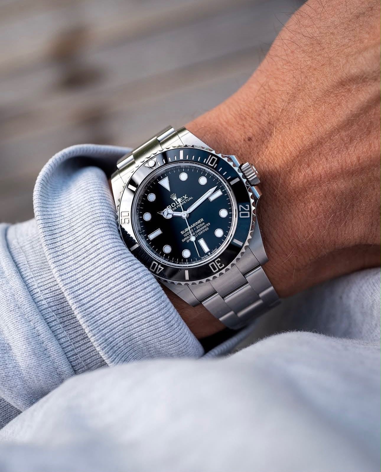 ROLEX SUBMARINE A BLACK DIAL AND BRUSHED STAINLESS STEEL OYSTER BRACELET AUTOMATIC WATCH