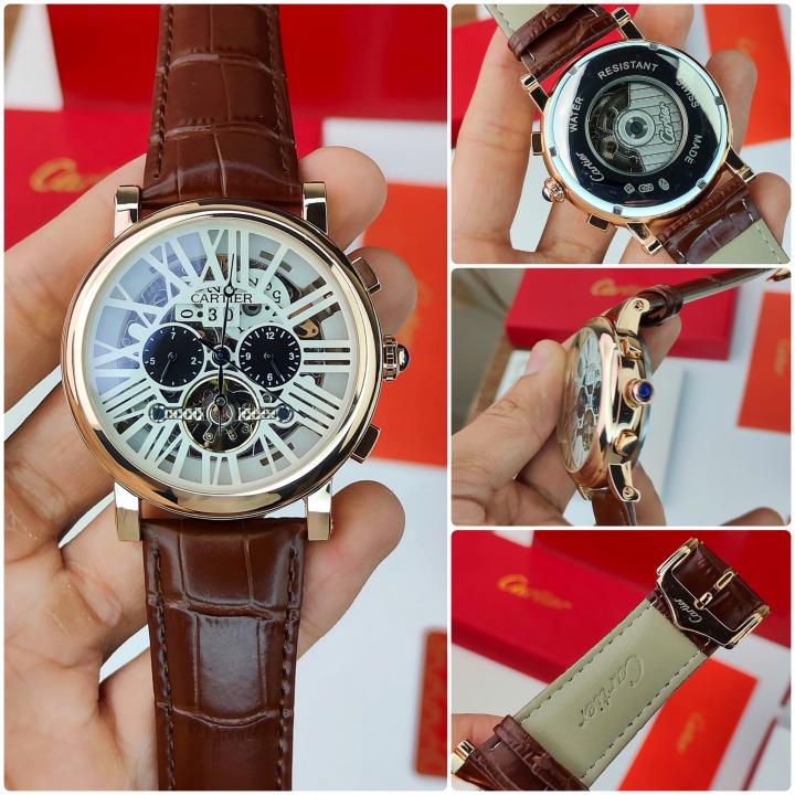 CARTIER A ROUND AUTOMATIC WATCH FOR MEN WITH A SKELETON DIAL AND BROWN LEATHER STRAP