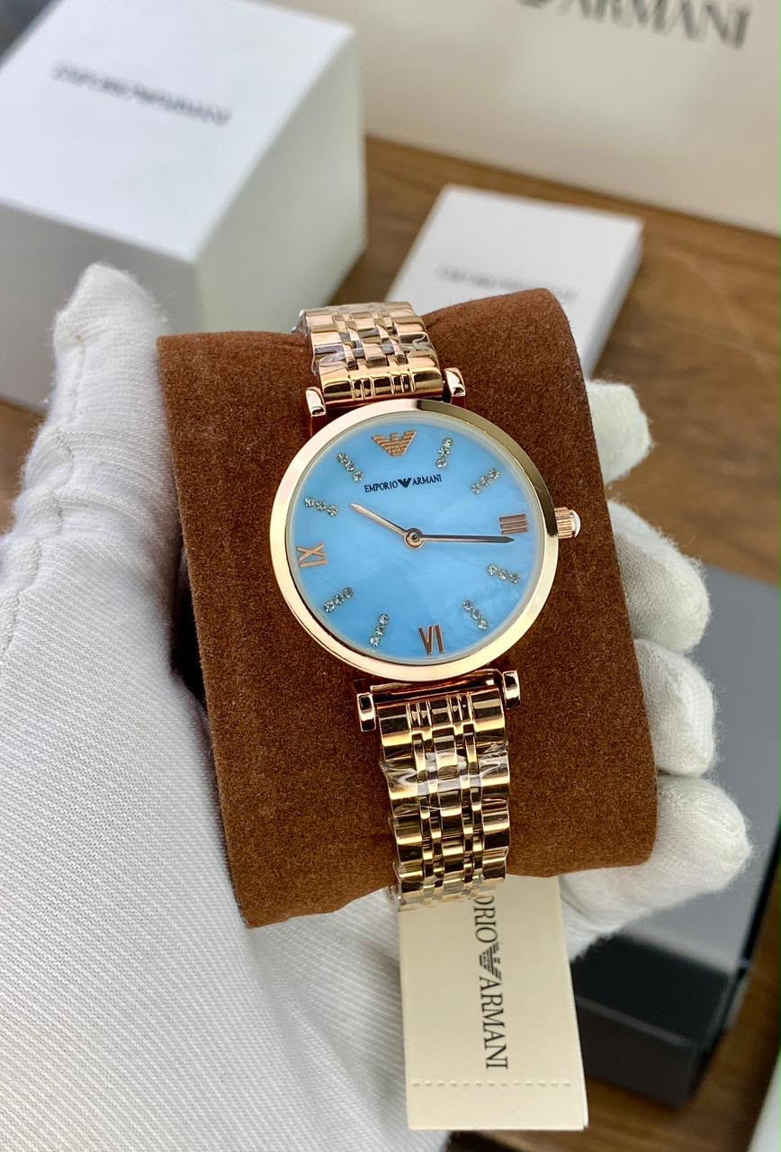 EMPORIO ARMANI WATCH A ROSE GOLD TONE STAINLESS STEEL BRACELET AND A LIGHT BLUE DIAL